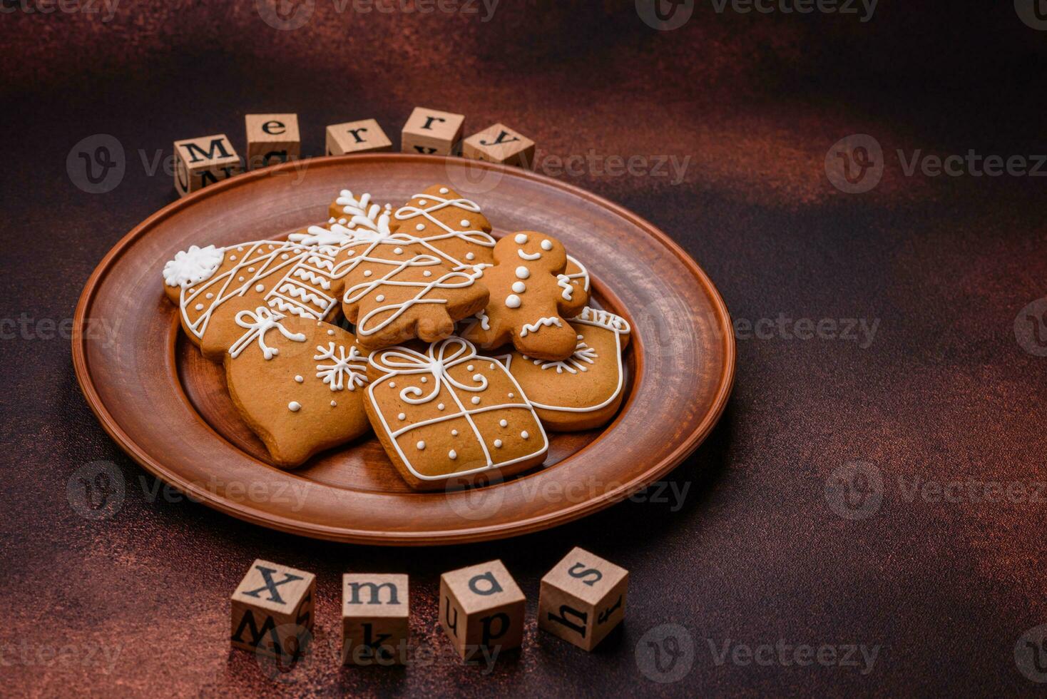 Beautiful delicious sweet winter Christmas gingerbread cookies on a bronze textured background photo