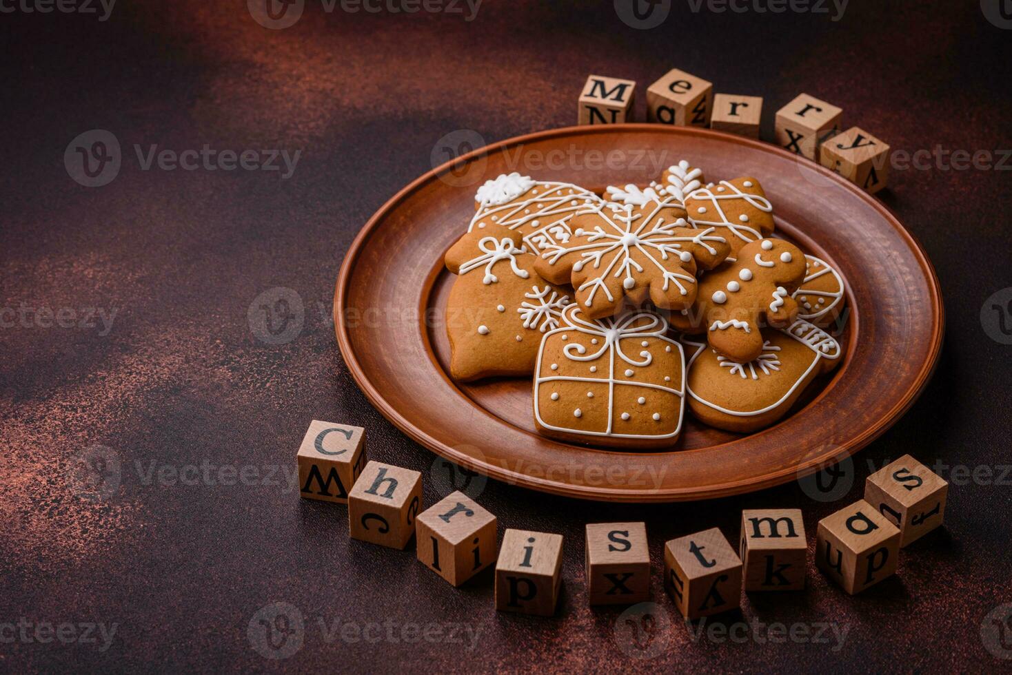 Beautiful delicious sweet winter Christmas gingerbread cookies on a bronze textured background photo