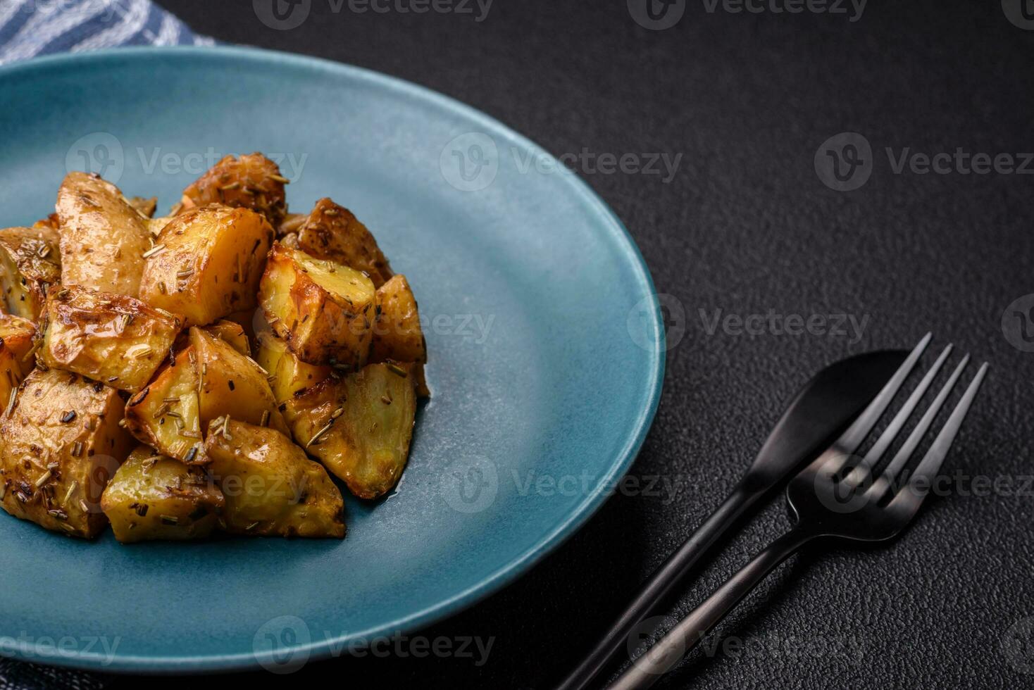 Delicious crispy fried potato wedges with salt, spices and herbs photo