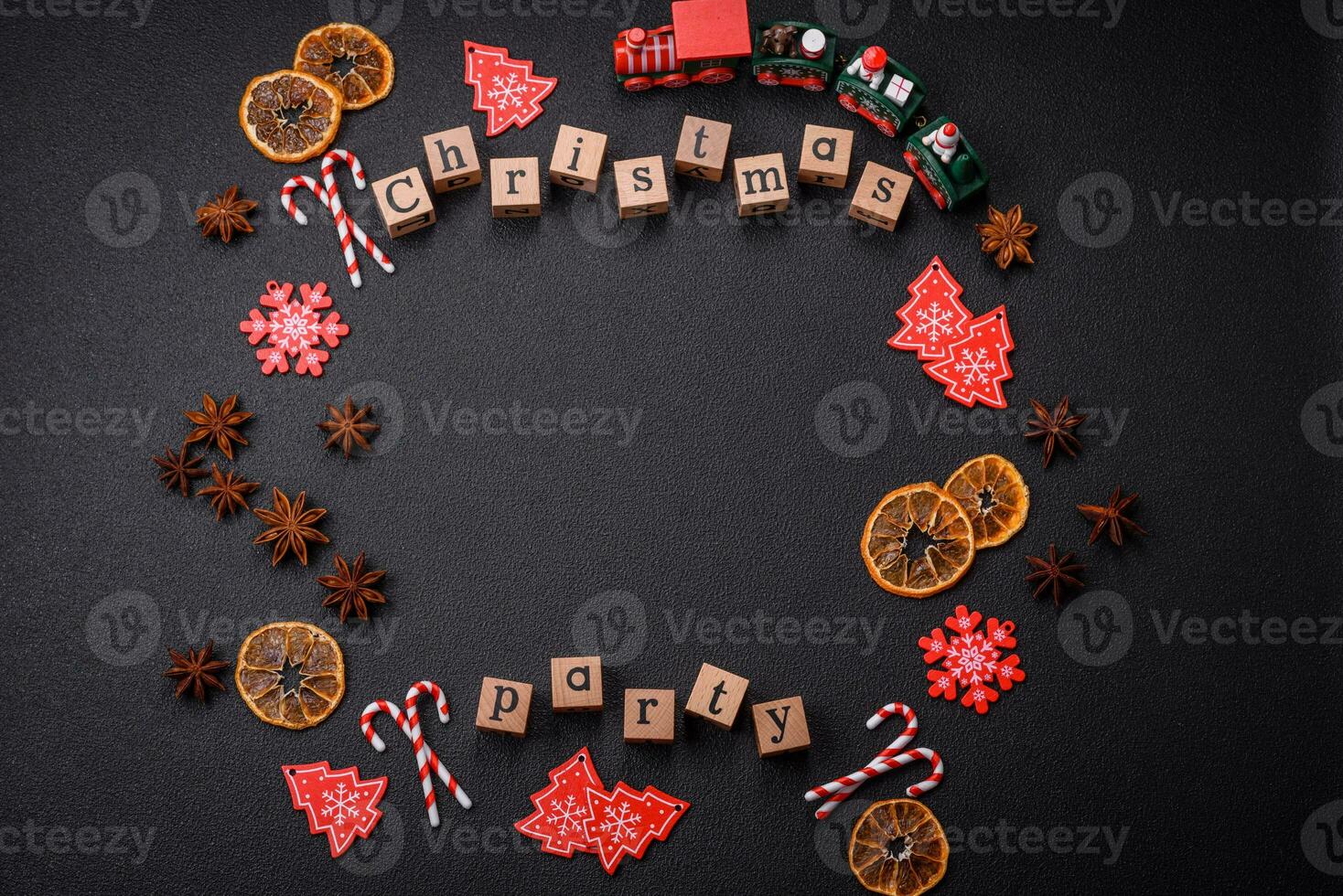 Christmas party inscription with wooden cubes on a dark concrete background photo
