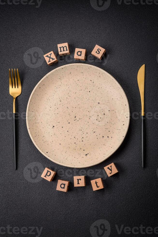 Christmas party inscription with wooden cubes on a dark concrete background photo