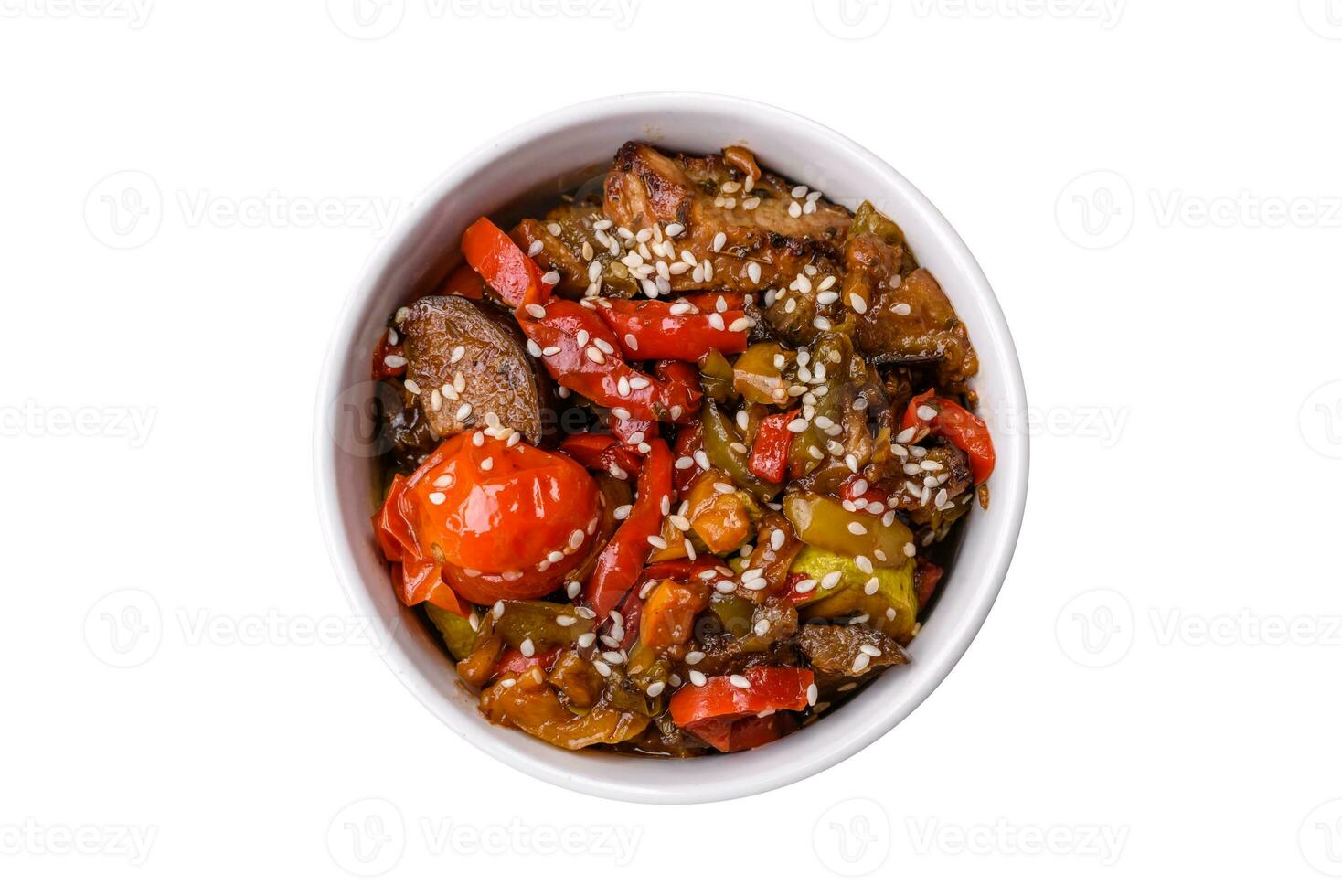 Warm salad with veal, tomatoes, peppers, zucchini, sesame, salt, spices and herbs photo