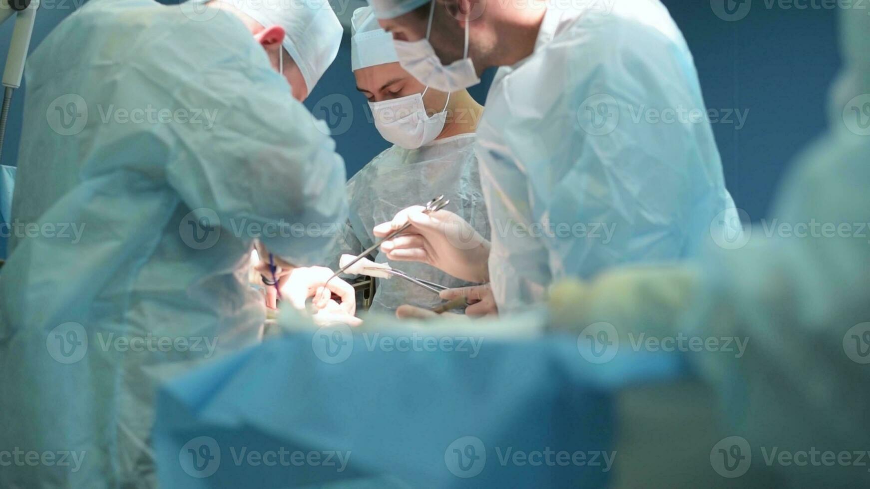 A highly qualified team of surgeons performs a complex operation to remove a pancreatic cyst using medical instruments photo