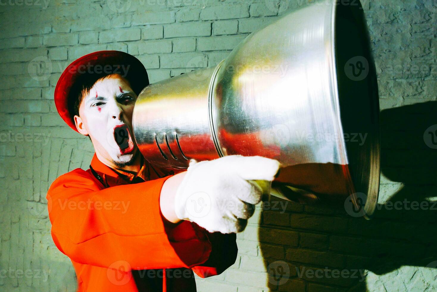 Mime took a metal lampshade and pretends to shout into the shout photo