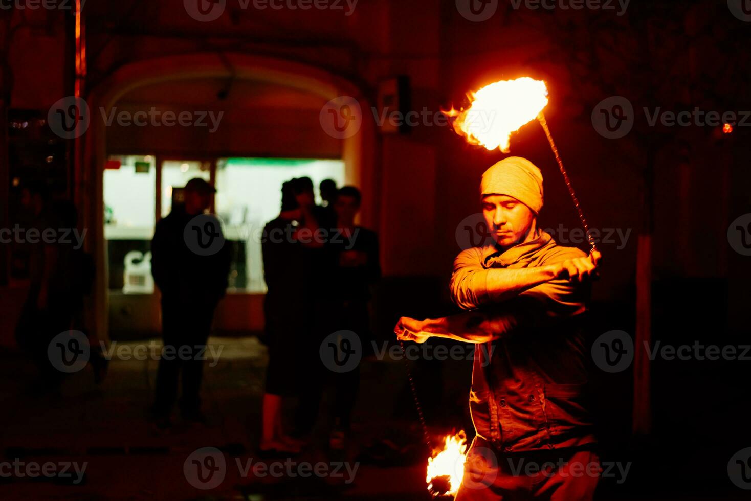 The guy on the street performs with fire torches photo