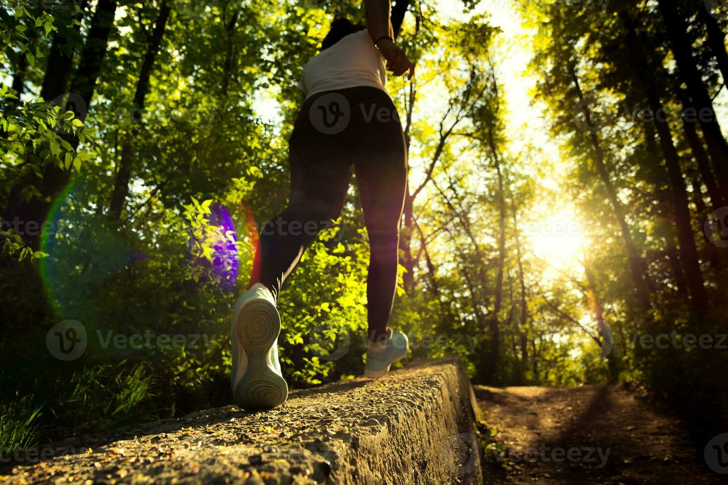 girl running in the forest view from below photo