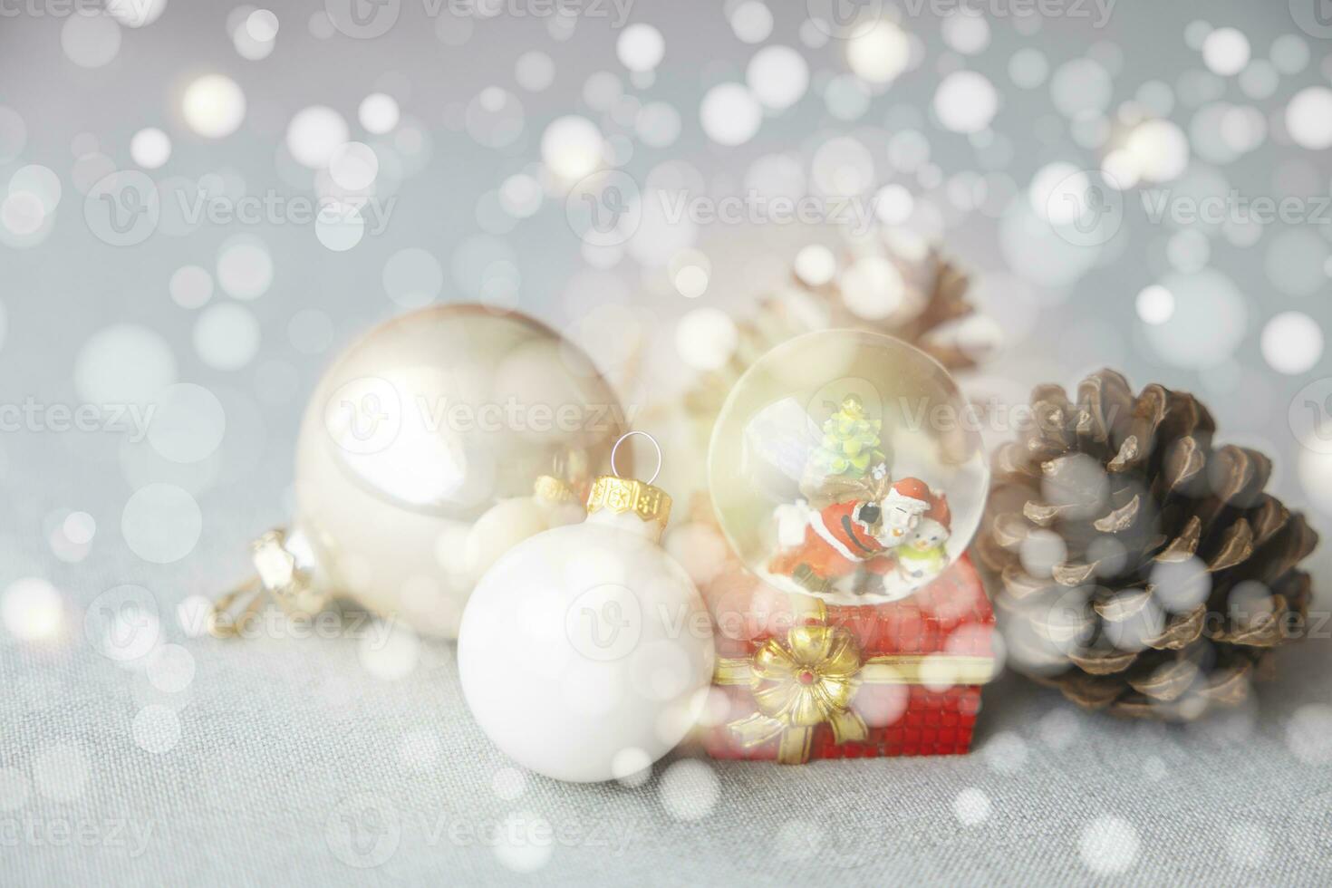 Christmas balls, Santa Claus in a Snow globe, and Pine cones on a white Cloth, set Against a Red Background and exquisite bokeh. New Year Celebration Atmosphere, about of Important day. photo