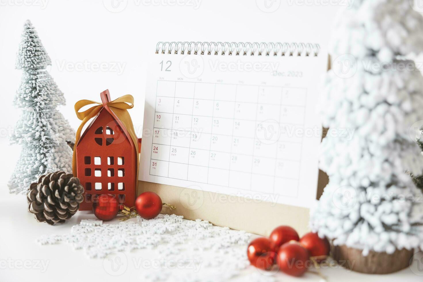 The calendar on December 25th, Christmas Day by the festive scene of beautiful Christmas tree adorned, with Christmas balls, pine cones. concept about Important day. photo