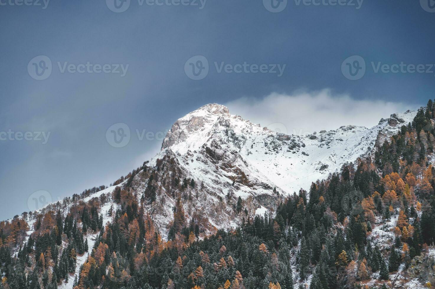 Mountain landscape in autumn with snow on top photo