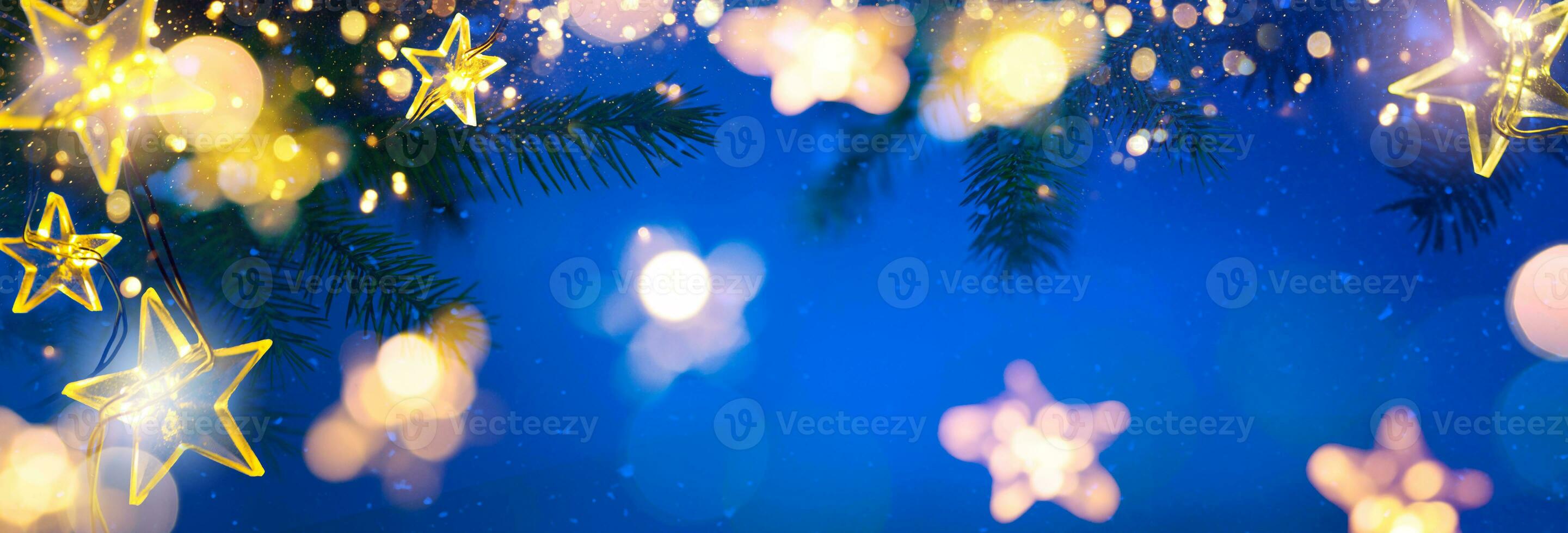 Christmas Tree Lights - Stars String Hanging At Fir Branches In Abstract Snowy Sky Background photo