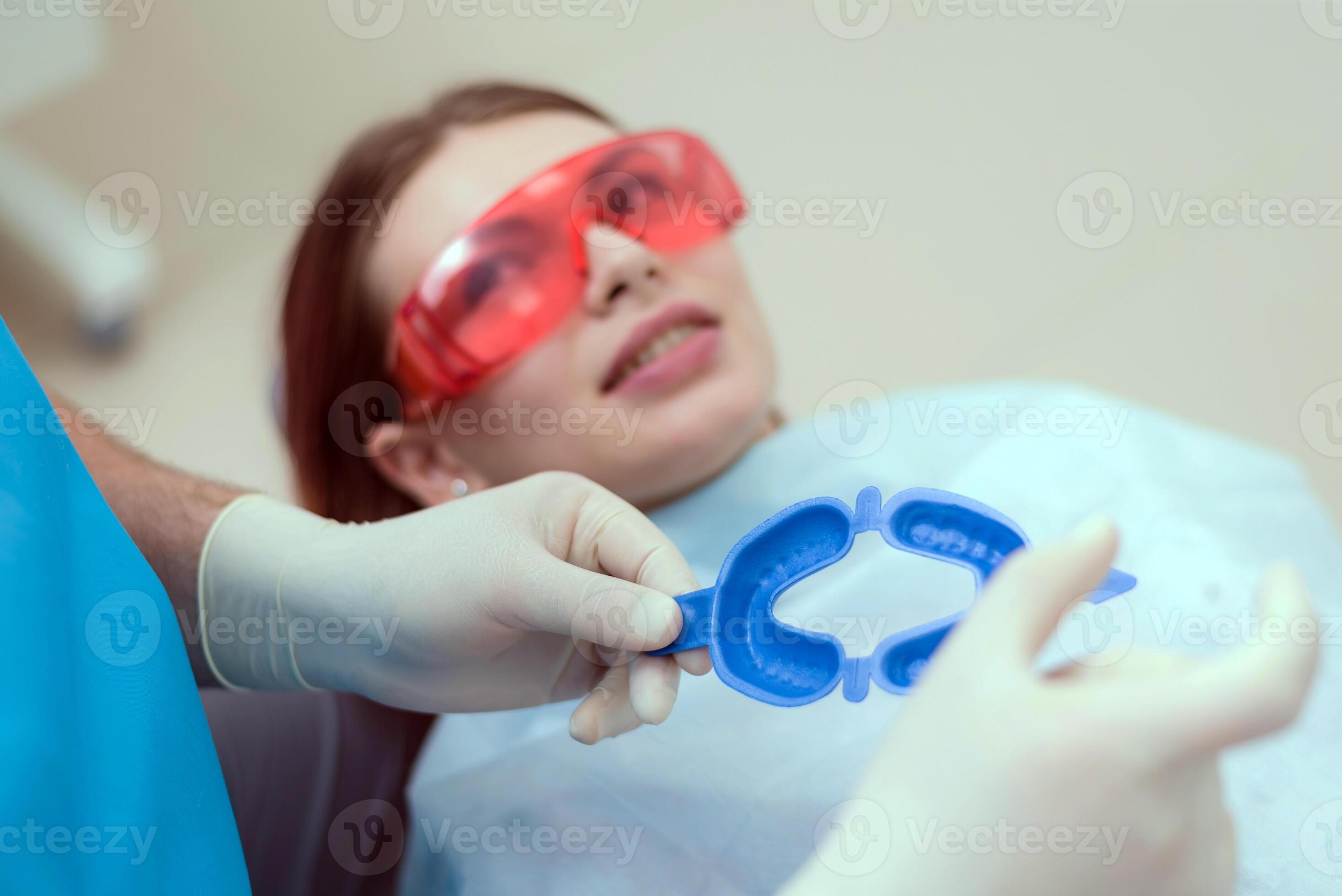 doctor orthodontist performs a procedure for cleaning teeth 35041470