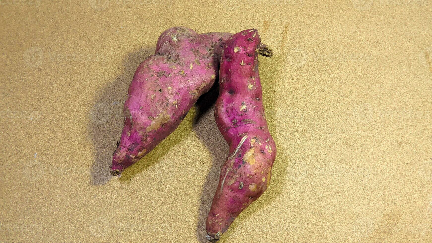 Two purple sweet potatoes on a white background photo