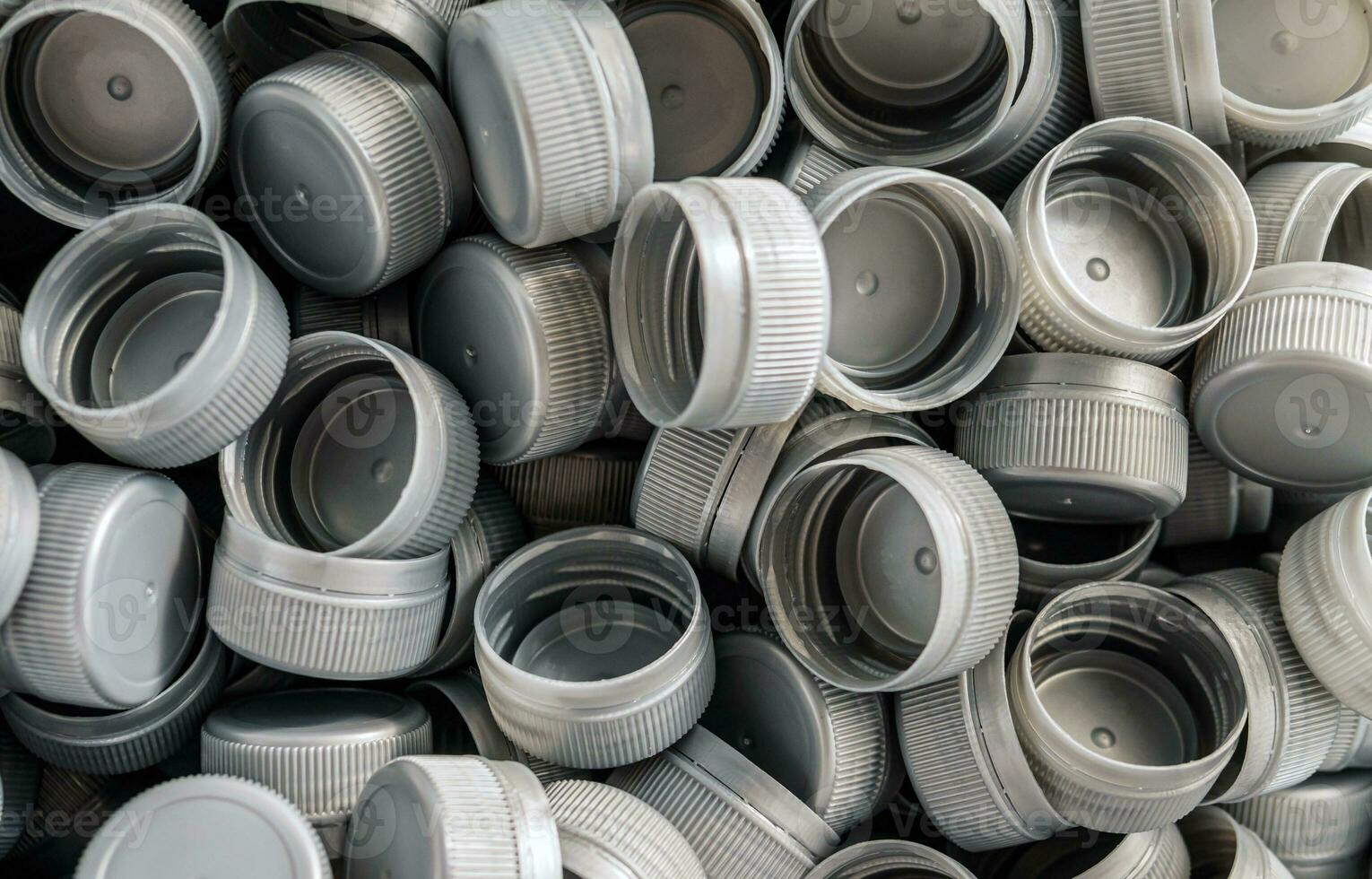 Top view grey plastic bottle caps.Recycling collection and production processing plastic bottle caps background photo