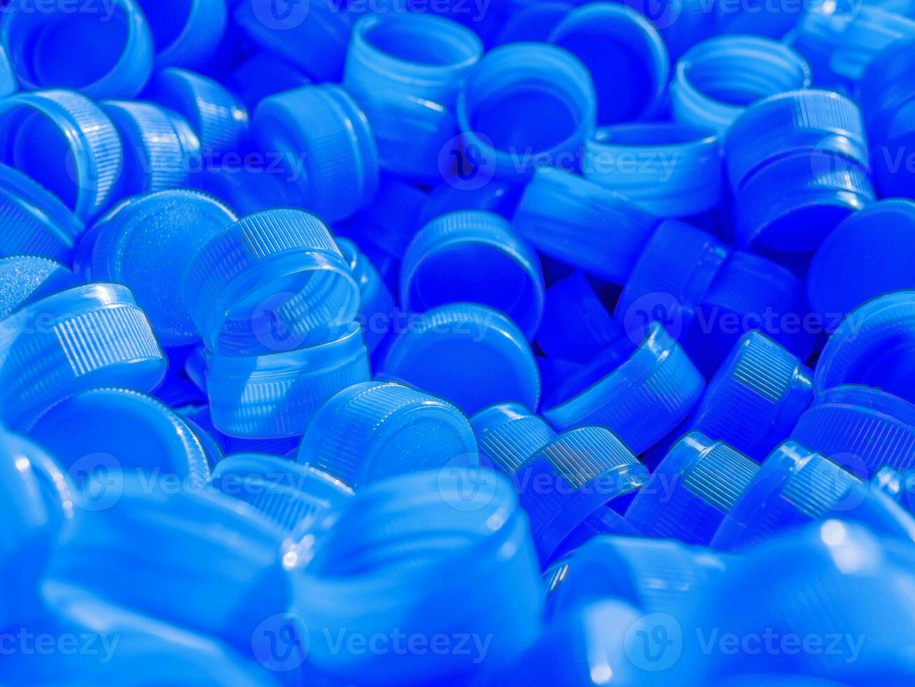 Top view Blue plastic bottle caps.Recycling collection and production processing plastic bottle caps background photo