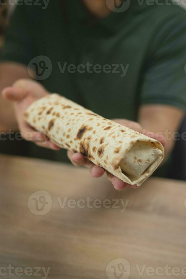 Homemade falafel in pita in hands. photo