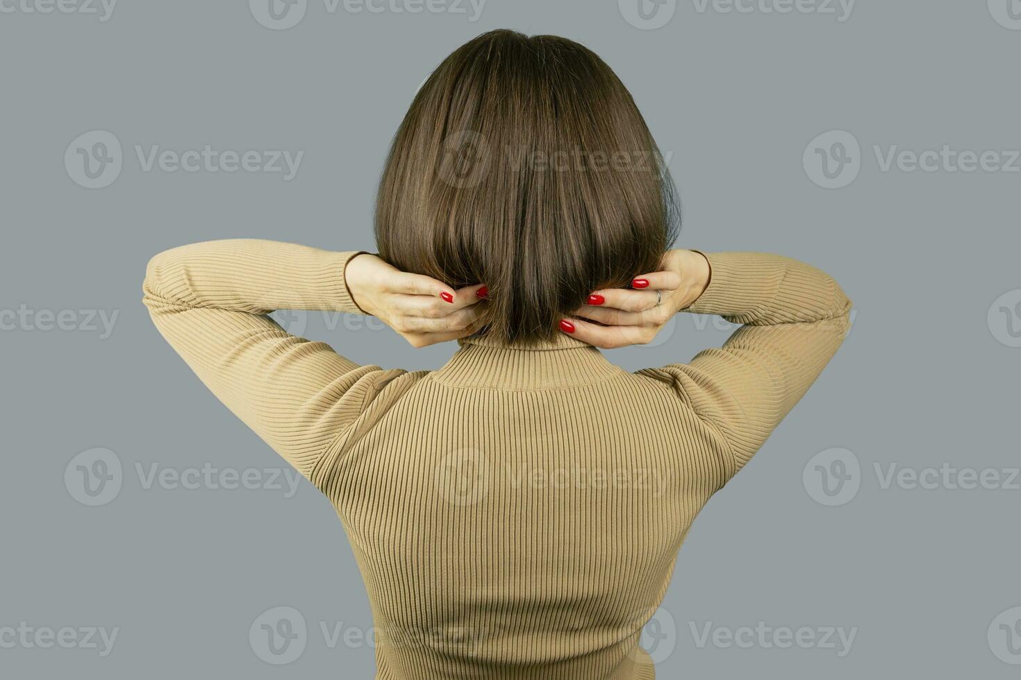 Woman with square hairstyle. Back to camera. Faceless. photo