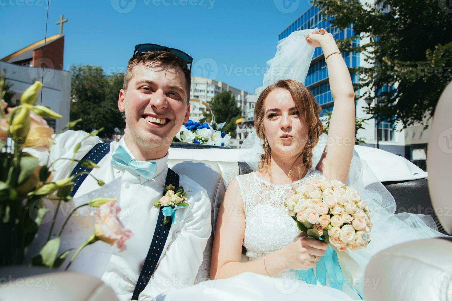 the bride and groom are photographed in the car photo