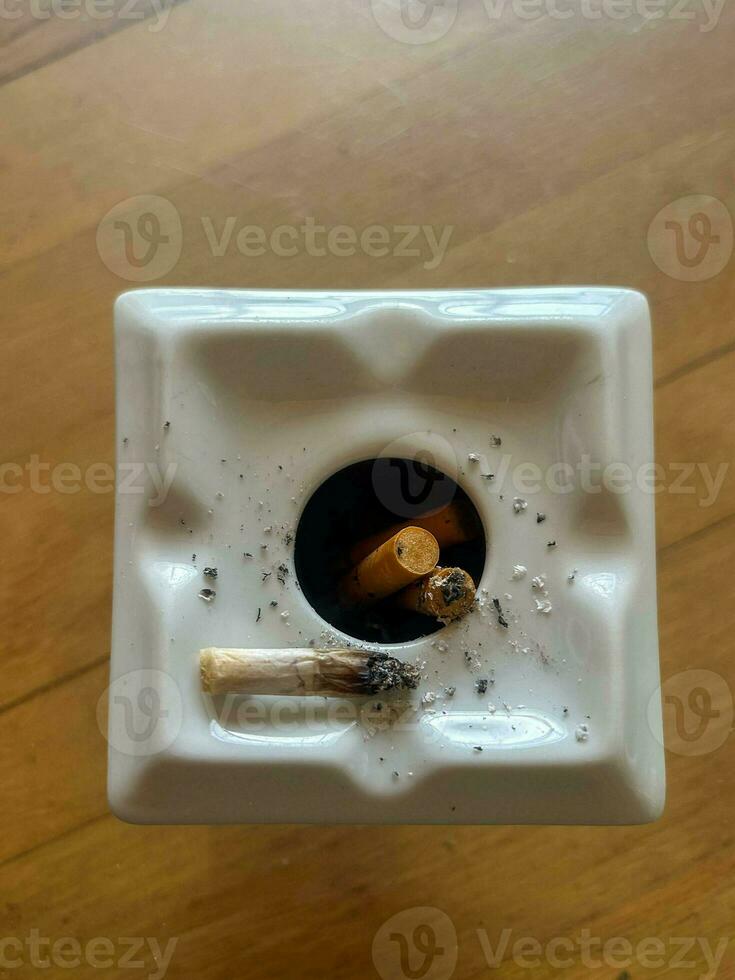 ashtray full of cigarette butts photo