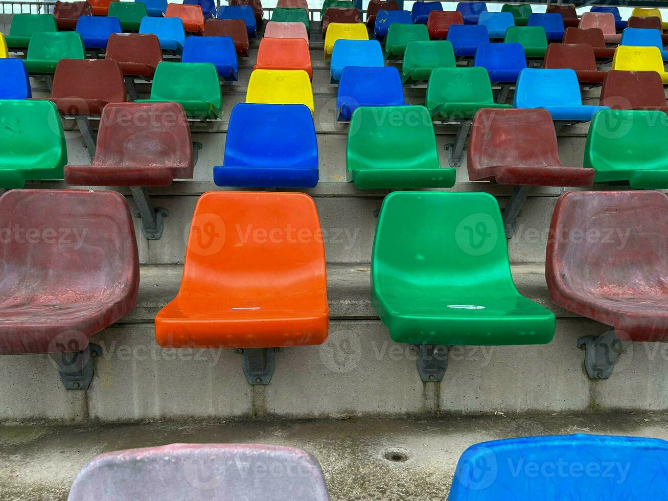 rows of plastic seats of different colors photo