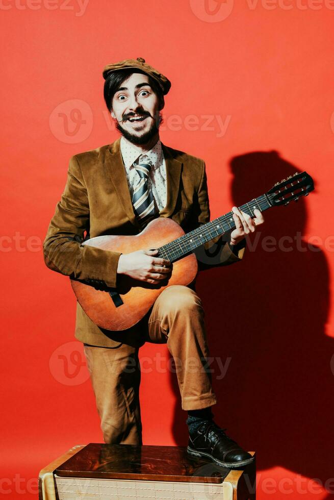 positive guy playing guitar in the Studio photo