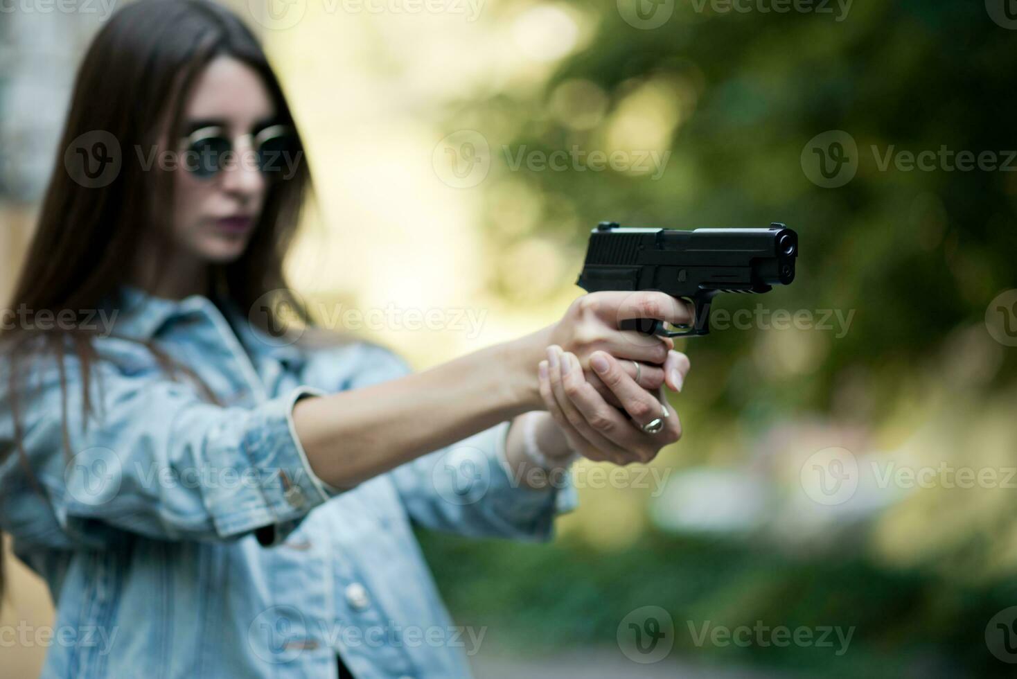 girl with a gun on the street learns to shoot photo