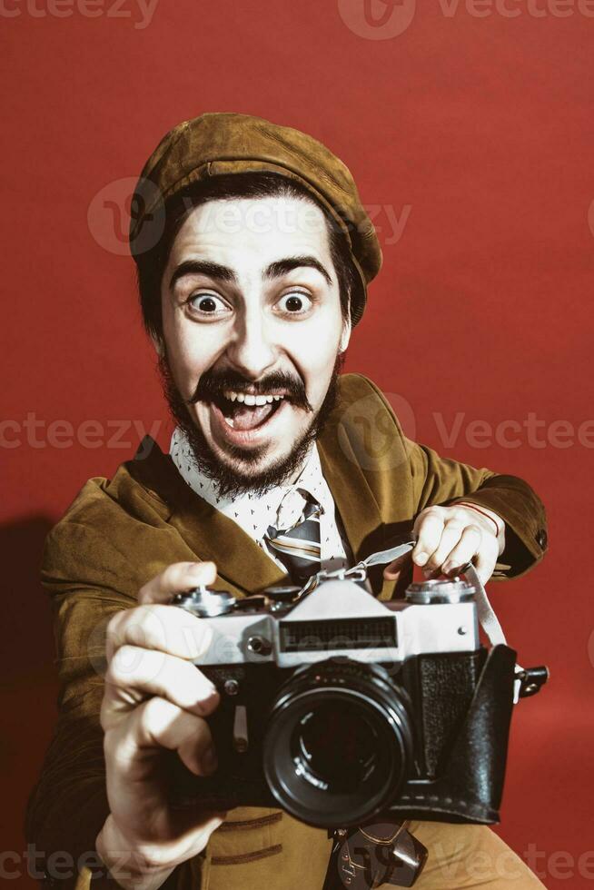 very positive photographer posing in studio with film camera photo