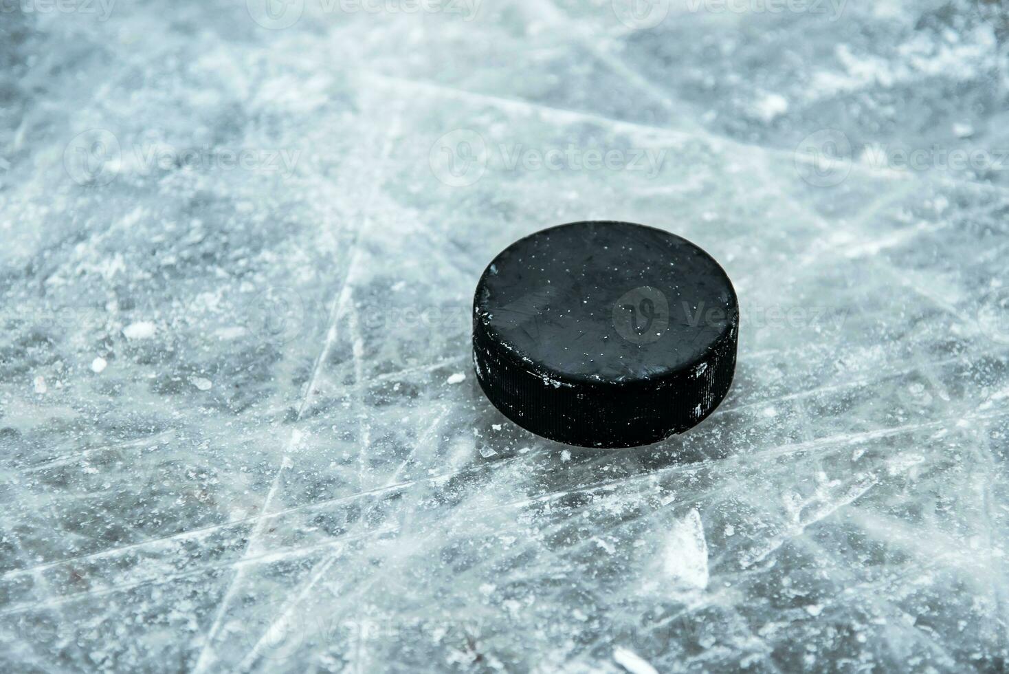 hockey puck lies on the snow close-up photo