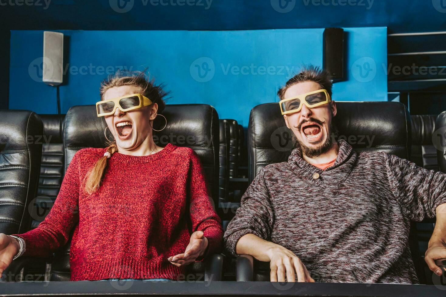 guy and girl 3d glasses are very worried while watching a movie in a cinema photo