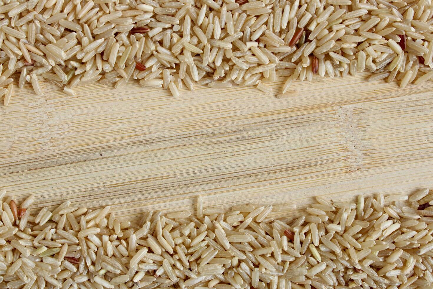 Brown Rice Grains on Wood Surface photo