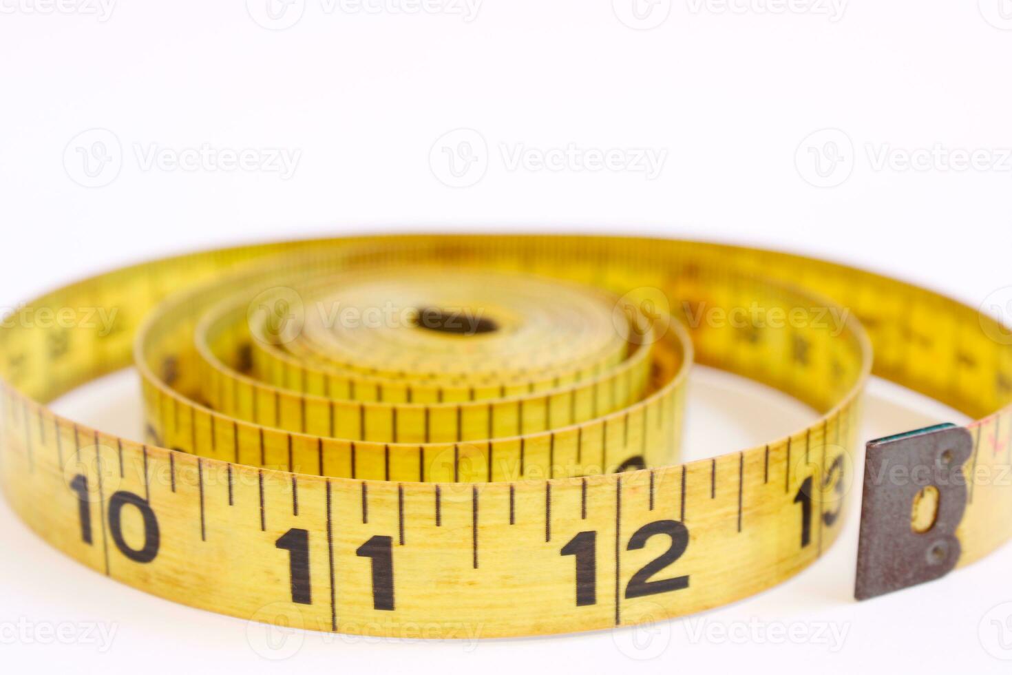 Yellow Tape Measure Close up on White Background photo