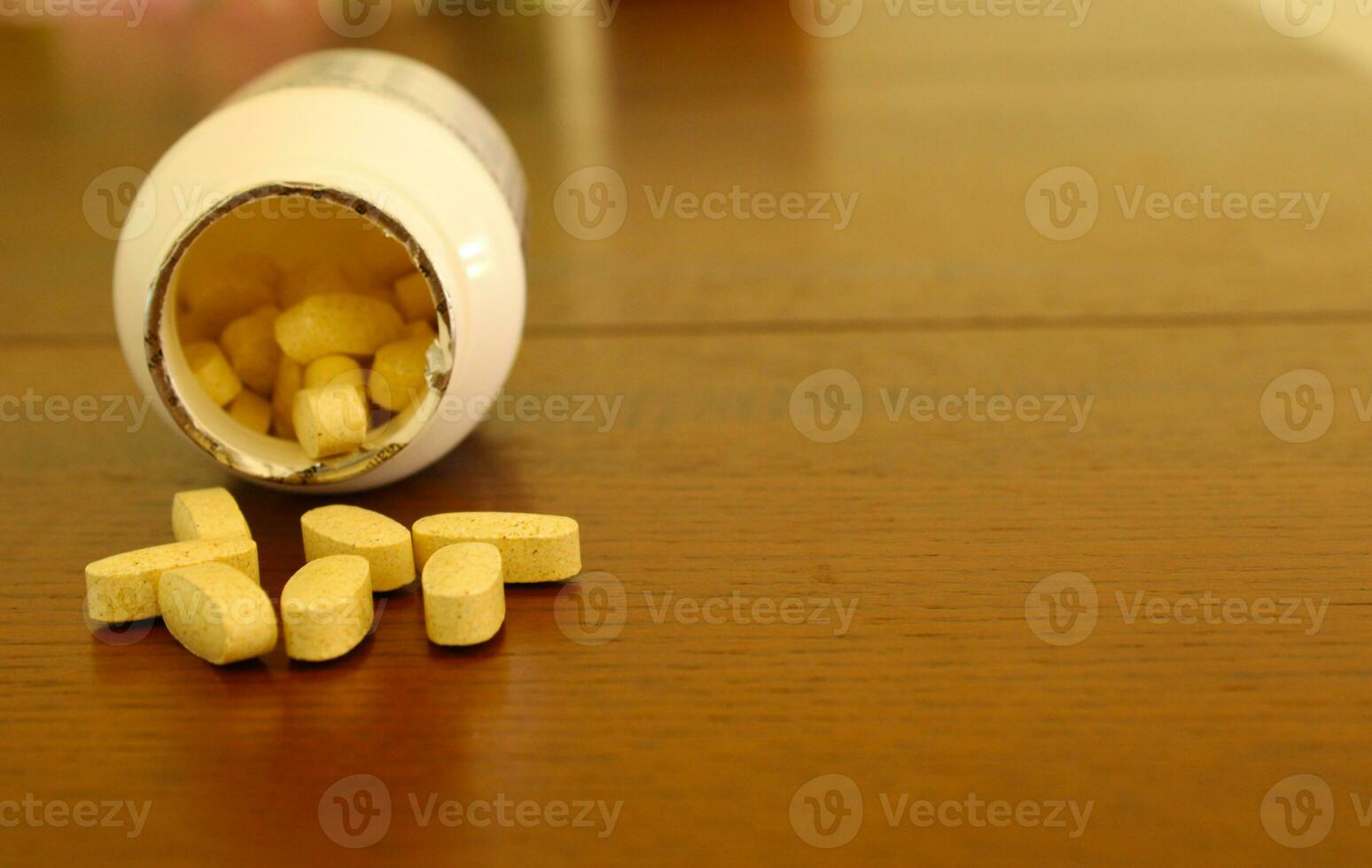 Pills on Table Surface with Open Container photo