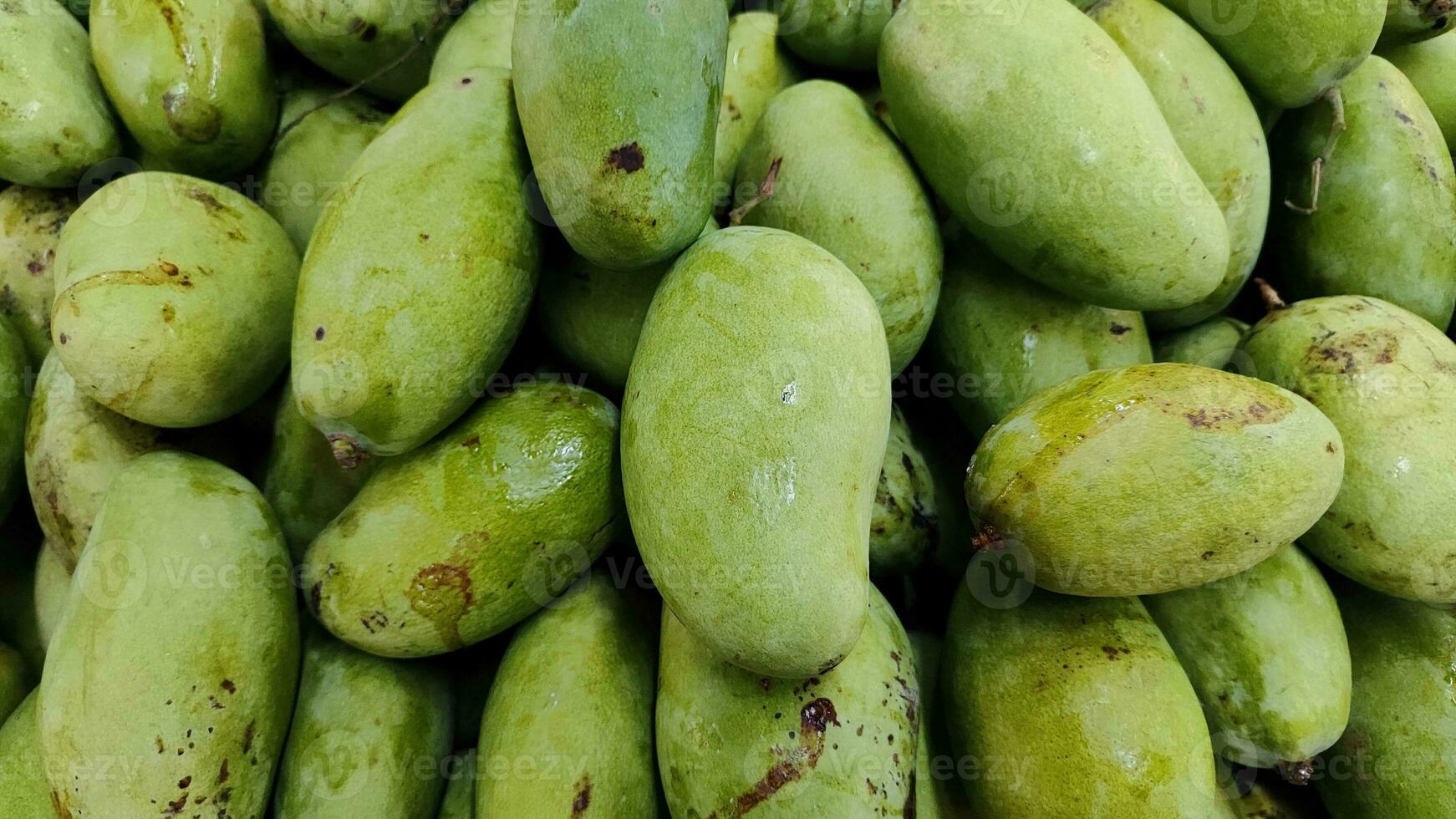 pile of mango fruits on the shelf in grocery supermarket, close up photo