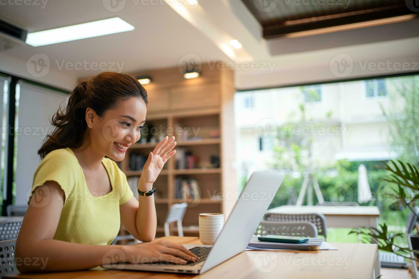Young woman having video call via computer in the home office.Business video conferencing. photo