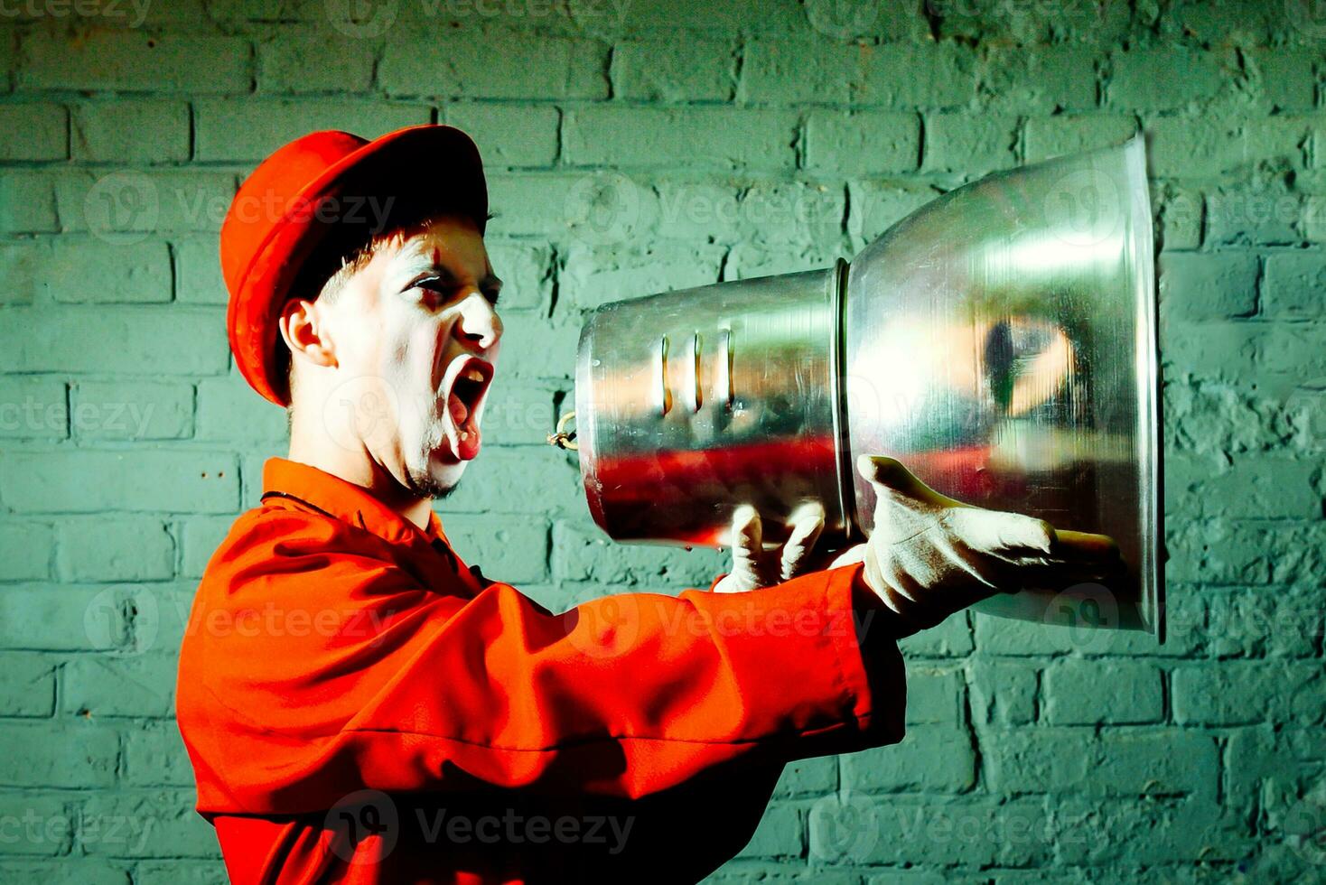 Mime took a metal lampshade and pretends to shout into the shout photo