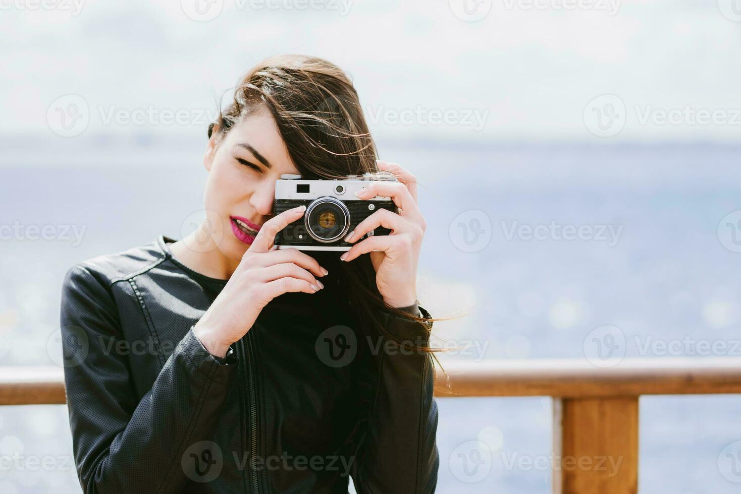 Attractive girl takes pictures with an old camera photo