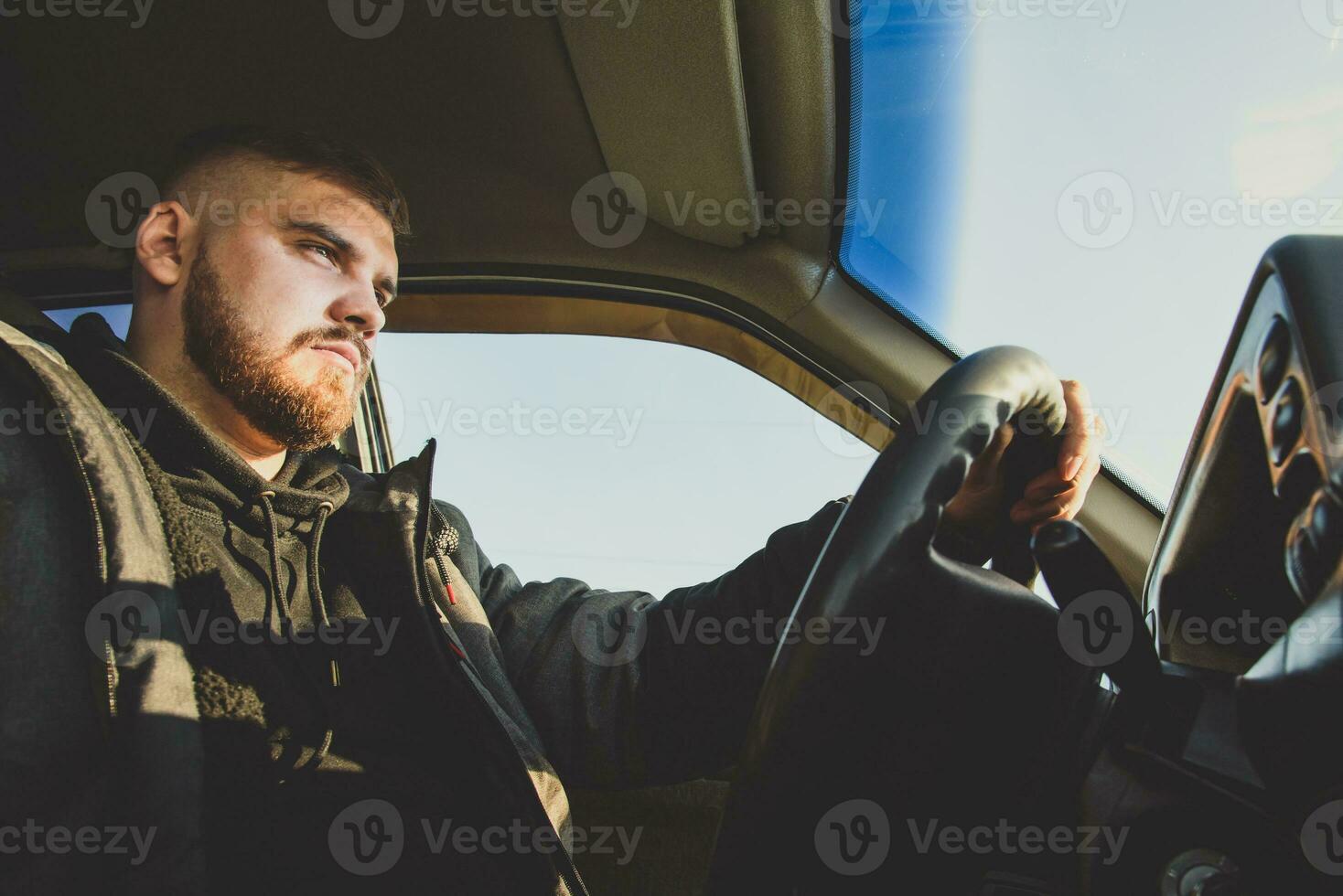 bearded man sitting behind the wheel of the Russian photo