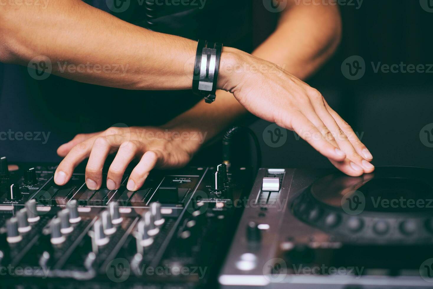 DJ's hands control the remote control close-up photo