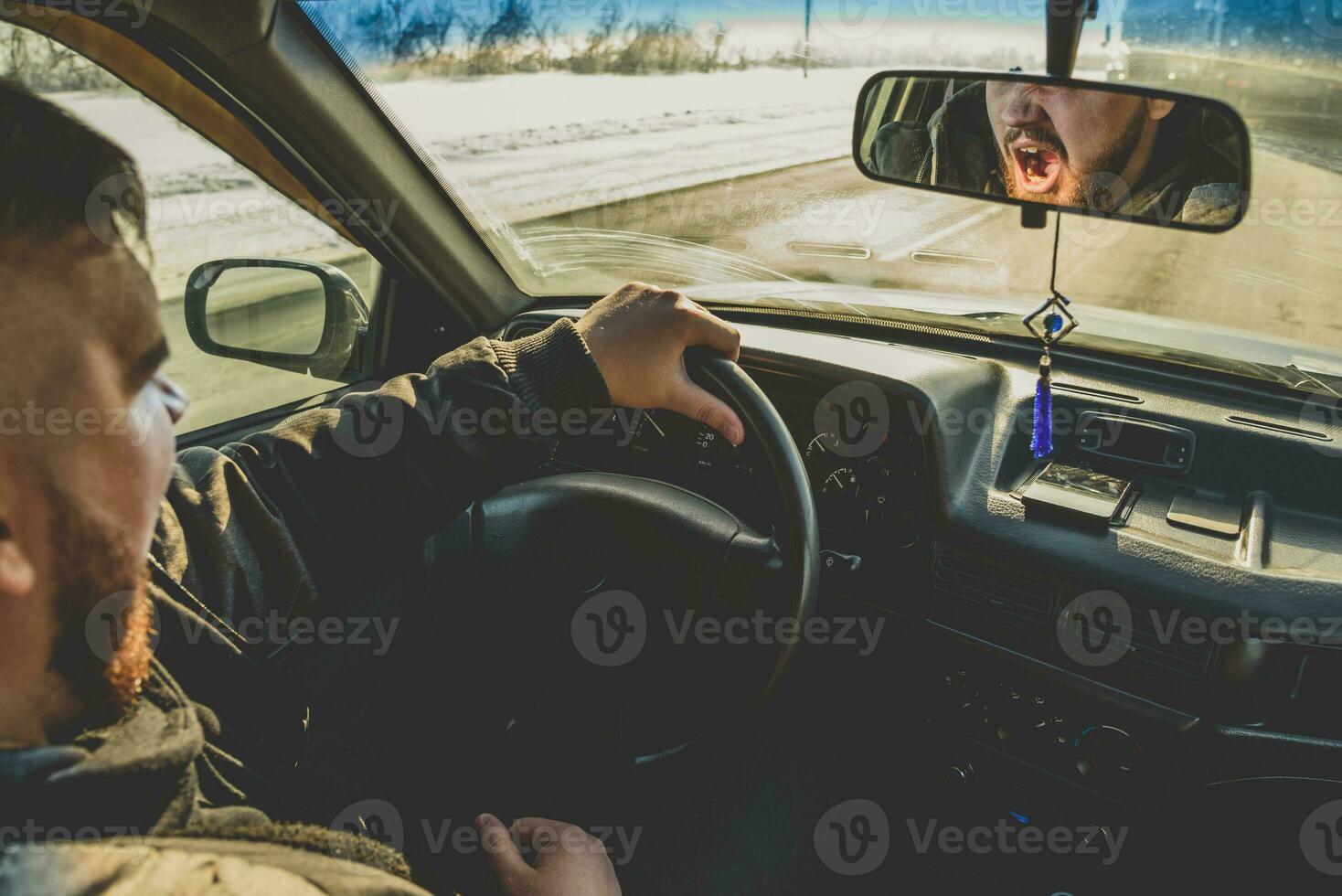 man tired to go and yawns in the car photo