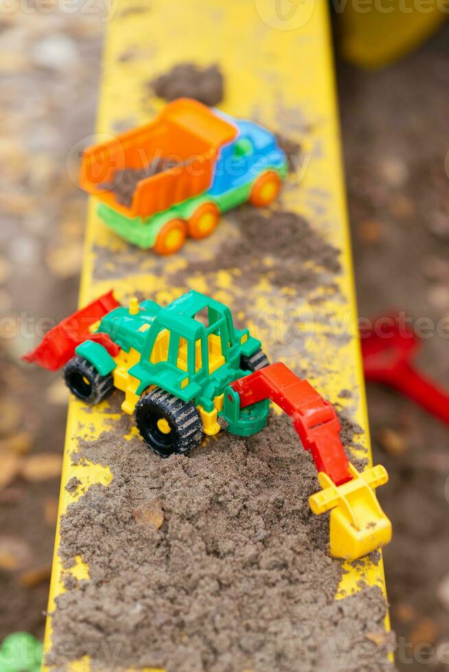 children's toys in the sandbox close-up photo