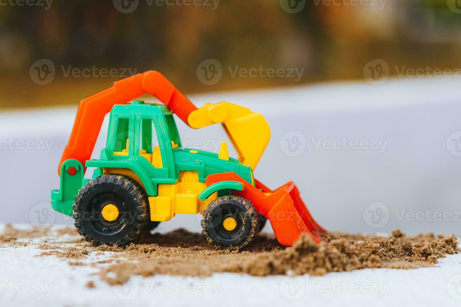 children's excavator in a sandbox close-up photo