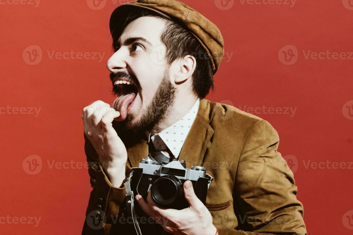 very positive photographer posing in studio with film camera photo