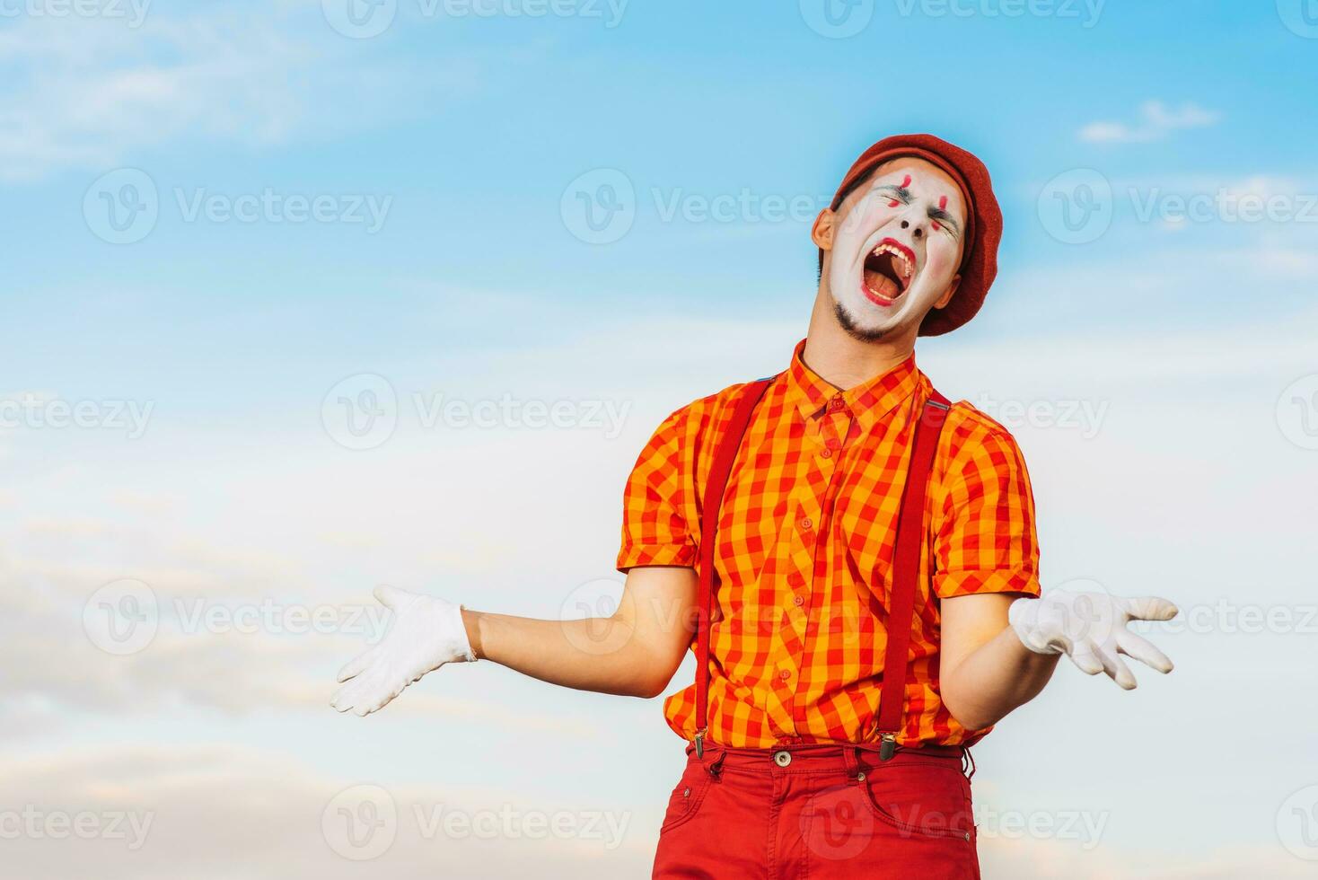 Mime shows pantomime against the blue sky photo