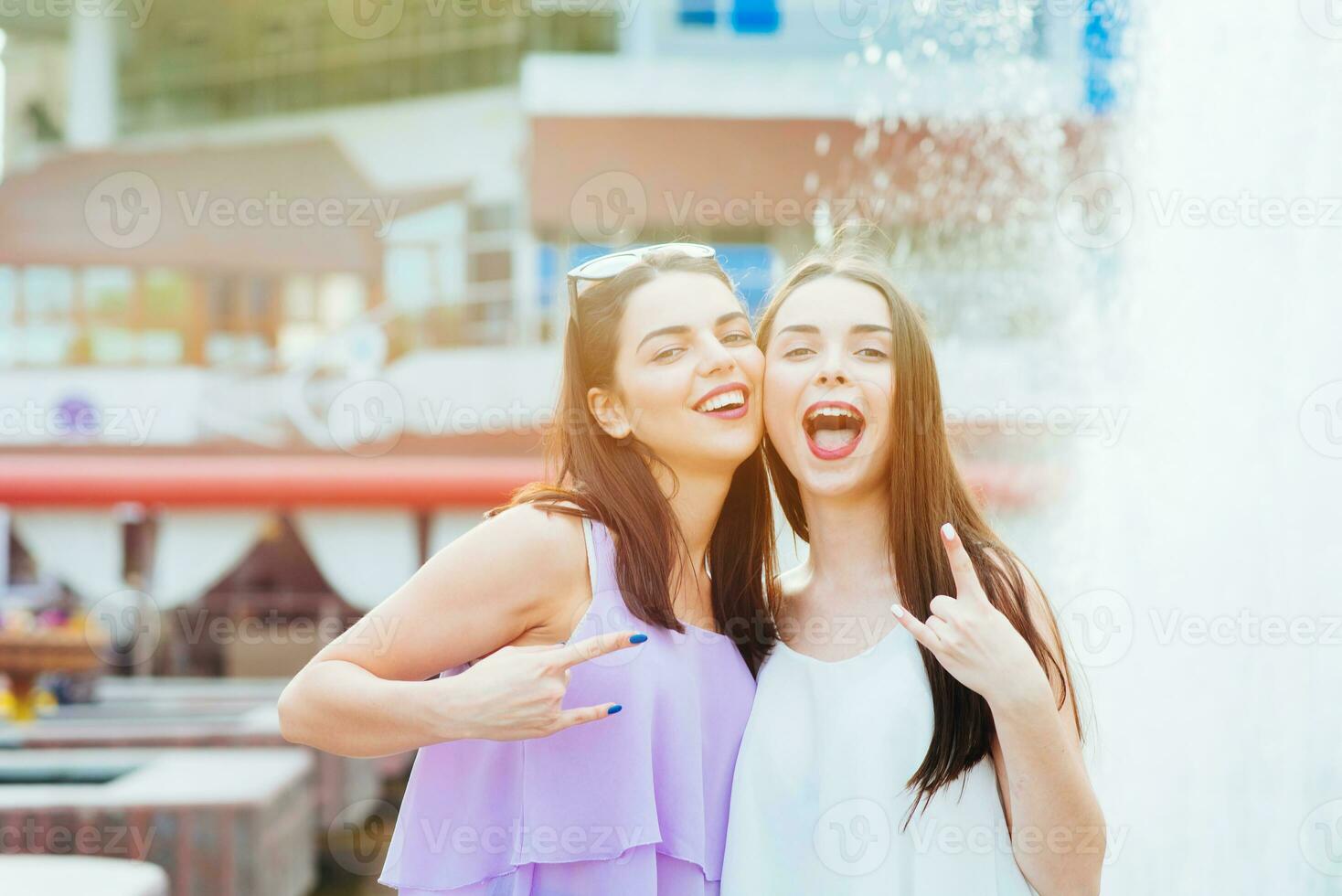 Two beautiful girls having fun on the street photo