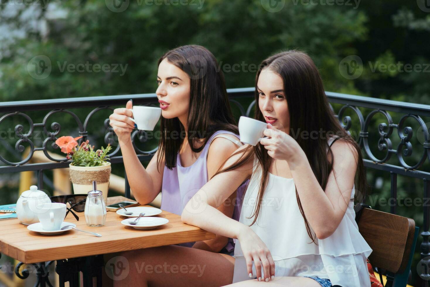 novias son sentado en café y Bebiendo té foto