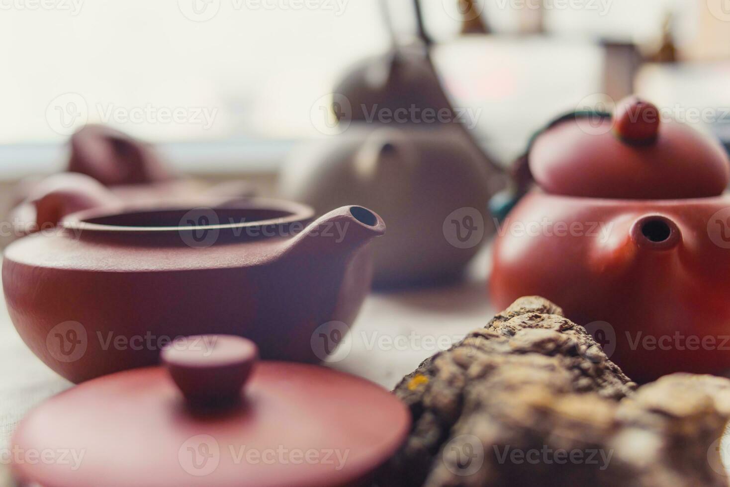 ceramic teapots stand on a window in a cafe photo