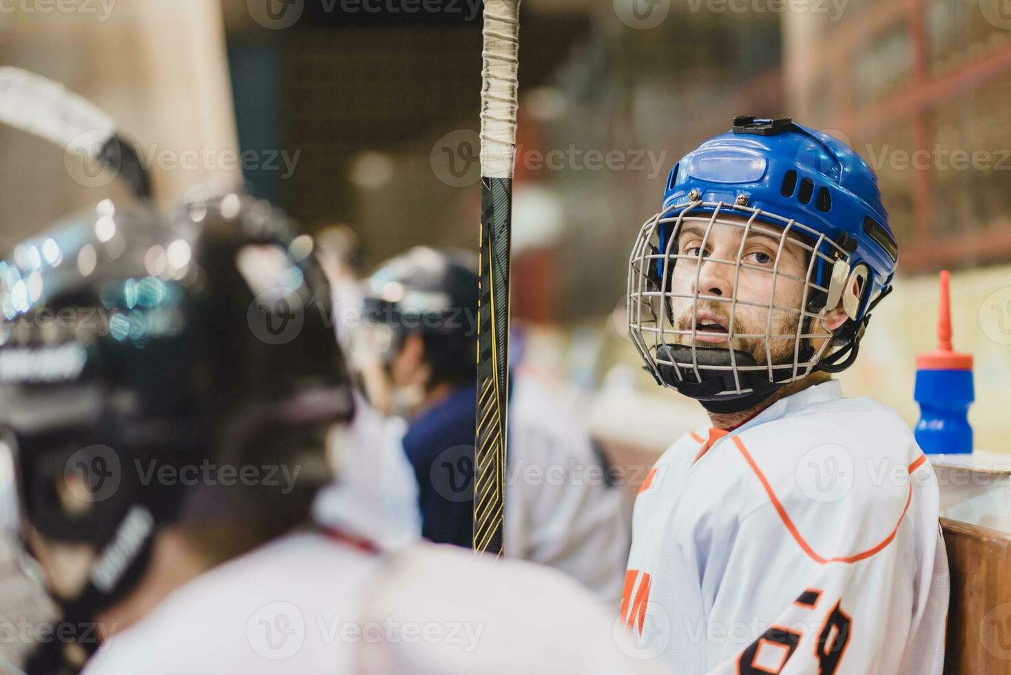 hockey players sit on the bench during the match photo