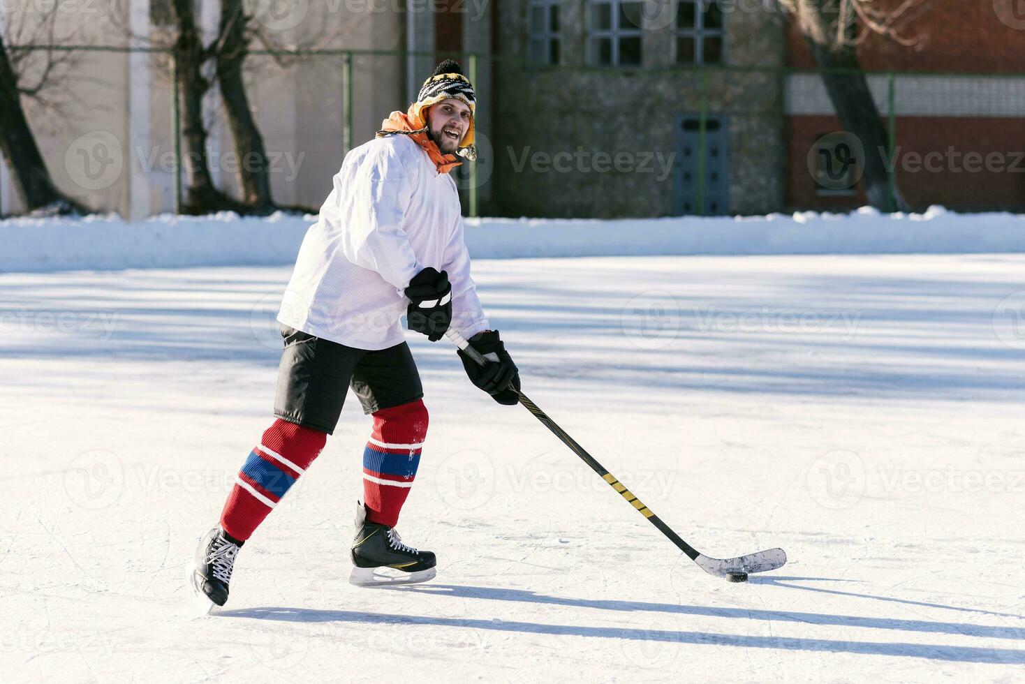 the man plays hockey on the rink photo