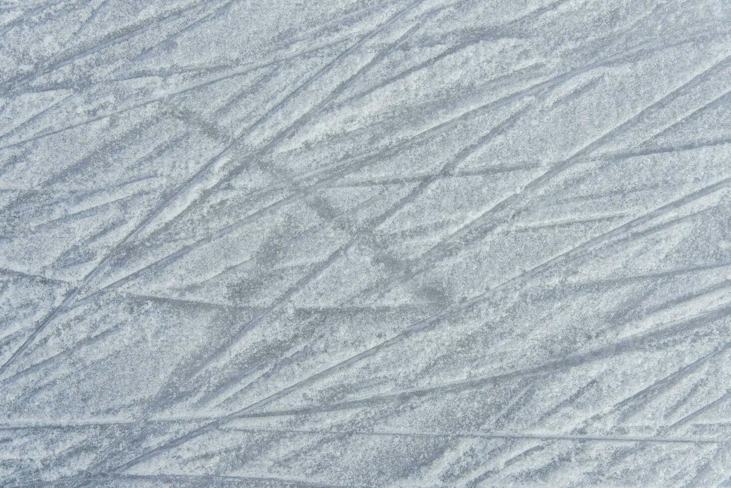 traces on the ice from skates on the rink photo