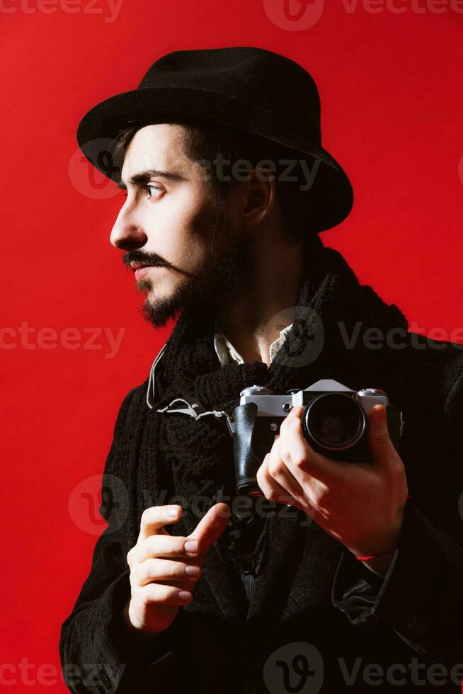 creative photographer posing in studio with camera photo