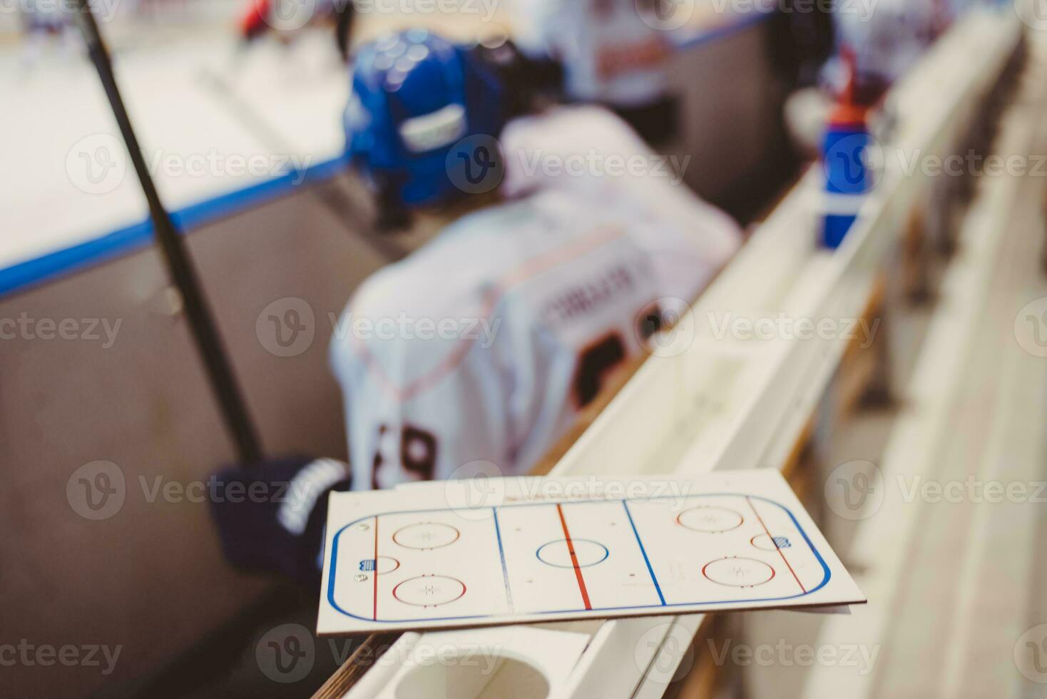 hockey players sit on the bench during the match photo